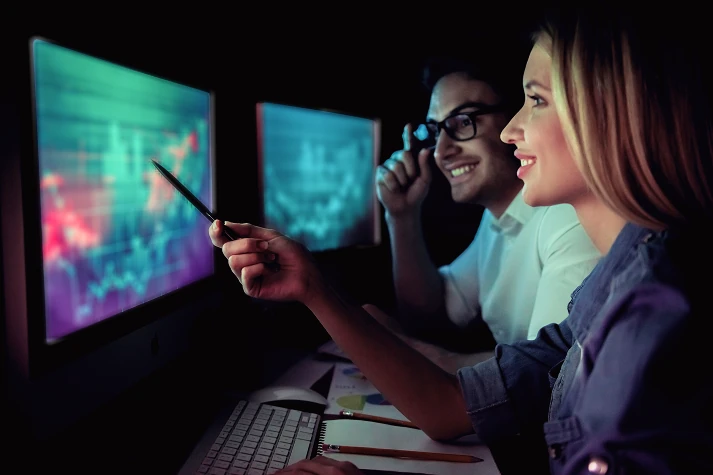 Traders analyzing markets on multiple screens