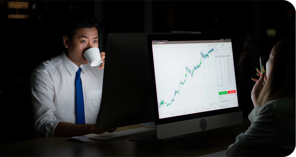 Trader analyzing charts on a desktop screen